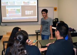 Jose Trevino helps students with science lesson.